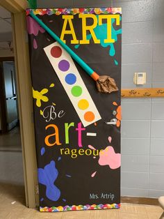 the door to an art classroom is decorated with colorful paint