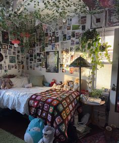 a bed room with a neatly made bed and lots of pictures on the wall