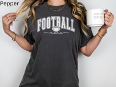 Elevate your game day style with this Comfort Colors® Football Mama t-shirt, a must-have for any football mom. It's the perfect addition to your game day wardrobe, so get ready to cheer on your favorite football team in style! Printed on Comfort Colors 1717 pre-shrunk, 100% cotton t-shirts that are known for their softness, durability and relaxed fit. They are made with a unique pigment-dyed process that gives them a vintage, lived-in look right from the start. The seams are double-needle stitch Collegiate Relaxed Fit Tops For Football Season, Crew Neck Tops For Football Season Game Day, Game Day Team Spirit T-shirt With Relaxed Fit, Fan Apparel Tops With Team Name For Football Season, Relaxed Fit Tops With Team Name For Football Season, Game Day Sports Fan Tops For Football Season, Sports Fan Tops For Football Season Game Day, Sports Fan Tops For Game Day During Football Season, Football Season Sports Fan Tops