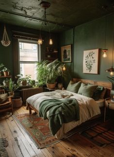 a bedroom with dark green walls and wooden flooring, potted plants on the far wall