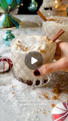 a person holding an ice cream sundae in front of some candy canes and candies