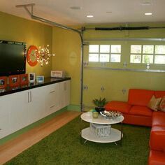 a living room filled with furniture and a flat screen tv mounted to the side of a wall