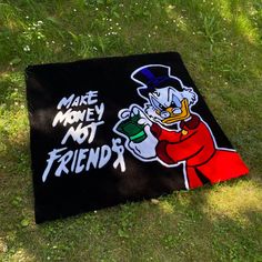 a black rug with the words make money not friends painted on it