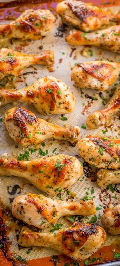 baked chicken wings with herbs and seasoning on a baking sheet, ready to go into the oven