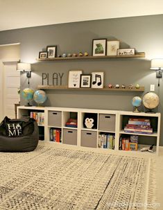 a living room filled with lots of furniture and bookshelves on top of it