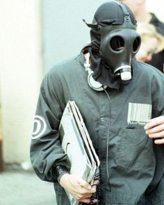 a man wearing a gas mask and holding a folder