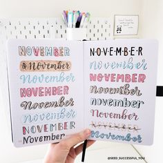 someone is holding up a notebook with the words november written in different languages on it