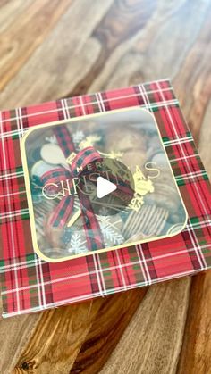 the box is decorated with red and green tartane plaid fabric, gold trimmings and an ornament