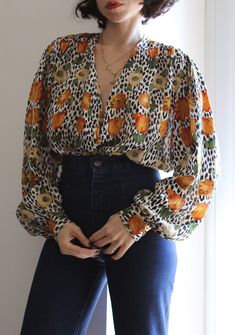 Vintage silk blouse with beautiful and fun animal & flowers print. V line neck, button down, big puff sleeves. Silk fabric with gold threads. So gorgeous and fun. Tailored. Excellent vintage conditions. Best fit from size 6 UK (oversize) to 10/12 UK. Model's size 6 UK 163 cm. Leopard Print Blouse For Fall, Vintage Silk Blouse With Floral Print, Long Sleeve Blouse With Bold Print For Fall, Vintage Floral Print Blouse With Puff Sleeves, Vintage Puff Sleeve Blouse With Floral Print, Fall Patterned Blouse With Bold Print, Patterned Long Sleeve Blouse With Bold Print, Multicolor Floral Print Blouse With Lantern Sleeves, Multicolor Floral Print Lantern Sleeve Blouse