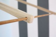 a piece of wood sticking out of the side of a wall with black and white stripes on it