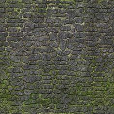 an old stone wall with moss growing on it