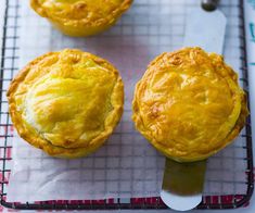 three small pies sitting on top of a cooling rack