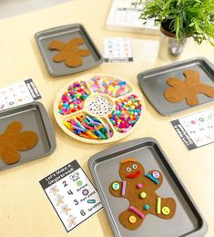 gingerbread cut out on trays with crafting supplies in front of them and plant