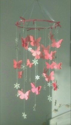 a mobile with pink butterflies hanging from it