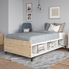 a bed with drawers underneath it in a room