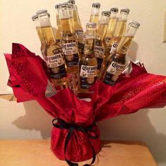 a bunch of bottles that are sitting on a table with red ribbon around the top