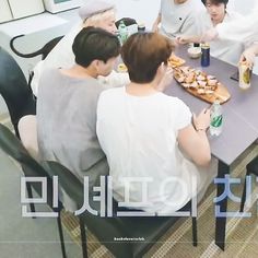 a group of people sitting around a table eating food