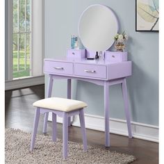 a pink vanity table with mirror and stool