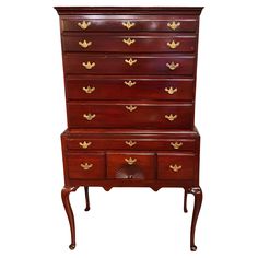 an antique chest of drawers with gold leaf decoration on the top and bottom drawer,