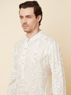 This Lucknowi kurta will instantly give an elegant look. Made from polyester cotton fabric, this 2 piece kurta set features a white lucknowi kurta, front buttons fastening, designer cuff buttons, and a mandarin collar. This lucknowi kurta has beautiful chikankari embroidery work all over. It is paired with white churidar pants. An ideal outfit for traditional & special events.

Size Chart For Men





	
	
					Men's Size Chart
		

		
		
						
				Size Chart For Men
				Custom Size Measurement G White Straight Kurta With Naqshi Details, White Straight Kurta With Naqshi, White Naqshi Kurta For Festive Occasions, White Naqshi Straight Kurta, Festive White Kurta With Naqshi Detailing, White Kurta With Naqshi For Eid, White Naqshi Kurta For Diwali, White Straight Kurta For Diwali, White Straight Kurta Bandhgala For Festive Occasions