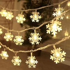 snowflake lights are hanging from a string