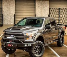 a black truck parked in a parking lot