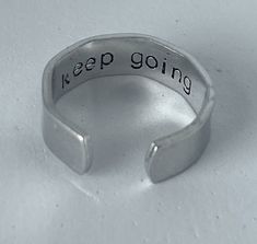 These gorgeous silver stackable personalised rings are the perfect gift for your favourite person or for yourself!  ⚡ 6mm x 57mm  ⚡ Made from aluminium, will not tarnish  ⚡ Adjustable sizing & can be worn with other rings ⚡ Fully customisable, any words can be stamped up to 15 characters including song lyrics - message for personalised orders.  ⚡ Black enamel may wear off in time, instructions for how to replenish will be included in your order. Please understand that I make everything, by hand, Personalised Rings, Present Christmas, Personalized Rings, Stamping Up, Stackable Rings, Adjustable Ring, Keep Going, Black Enamel, Favorite Person