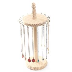 a wooden jewelry holder with chains hanging from it's sides and two necklaces attached to the top