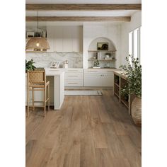 a kitchen with wood floors and white cabinets