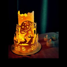 a lit up cake sitting on top of a table