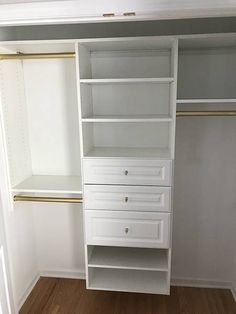 an empty closet with white shelves and drawers