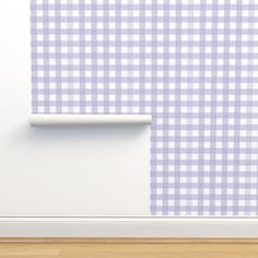 a white and pink checkered wall next to a wooden floor