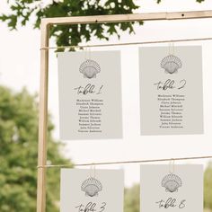 the seating cards were hung from strings with seashells on them