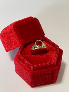 Amazing vintage 14k yellow gold created ruby ring, circa 1960s! The created red ruby weighs an estimated 1.21 carats, is oval cut, and is a stunning deep red. The setting contains a classic design with a high polish finish. Classic statement piece of fine retro jewelry showcasing a stunning created ruby, circa 1960s! ERA - Circa 1960s, Retro METAL / MATERIAL - 14k yellow gold, 1 created ruby (estimated 1.21 carats) [Synthetic ruby contains essentially the same chemical composition & properti Formal Ruby Signet Ring With Bezel Setting, Classic 14k Gold Red Signet Ring, Classic Red 14k Gold Signet Ring, Ruby Signet Ring With Bezel Setting For Formal Occasions, Classic Red Signet Ring Stamped 14k, Vintage Ruby Signet Ring In Yellow Gold, Vintage Yellow Gold Ruby Signet Ring, Vintage Yellow Gold Signet Ring With Ruby, Classic Red Ruby Ring In 14k Gold