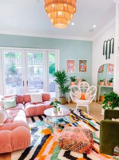 a living room filled with furniture and a chandelier hanging over the top of it