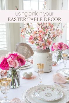 an easter table setting with pink flowers and eggs