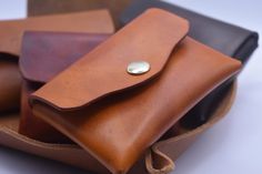 three leather pouches are stacked on top of each other, one has a coin in it