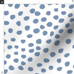 a white and blue polka dot fabric with small dots on the back half of it