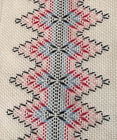 a cross - stitch pattern with red, white and blue colors on it's side