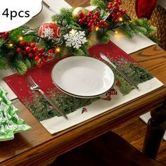 the table is set with christmas decorations and place settings