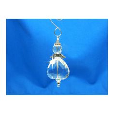 a clear glass ornament hanging on a blue background