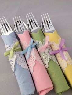 four napkins with forks tied to them in different colors