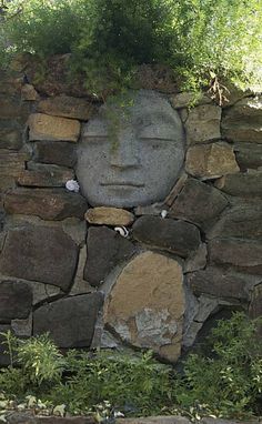 a stone wall with a face carved into it