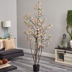 a living room with two couches and a tree in the middle of the room