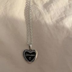 a heart shaped pendant on a white sheet