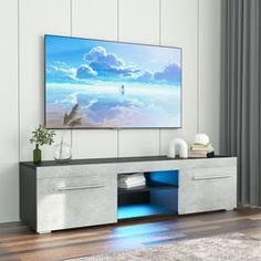 a flat screen tv mounted to the side of a wall in an empty living room