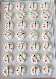 a pan filled with decorated cookies on top of a table