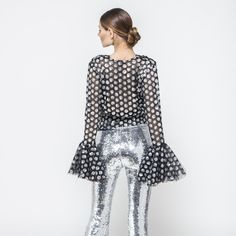 Inspired by the rock and roll of the 80s, this fabulous wrap sequin top is all about that hard glamour and edgy style. With flares on the sleeves, you won't be able to resist dancing the night away in this stunner.  Features a Relaxed fit, allover Sequins top, V neckline, Long sleeve,  Step-in style. Outer 100% Polyester/ Lining 100% Polyester Crepe de Chine/ Delicate dry clean only/ Do not machine wash or tumble dry/ For a post-travel refresh, we advise using a cool iron or a gentle steam on th Glamorous Contrast Sequin Blouse For Night Out, Glamorous Sequin Blouse For Night Out, Glamorous Sequin Tops For Night Out, Disco Style Tops For Night Out In Fall, Fitted Sequin Party Tops, Fall Disco Night Out Tops, Glamorous Sequined Tops For Party Season, Chic Sequin Party Tops, Chic Party Tops With Contrast Sequin