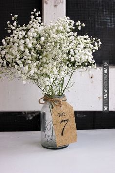 a mason jar filled with baby's breath flowers