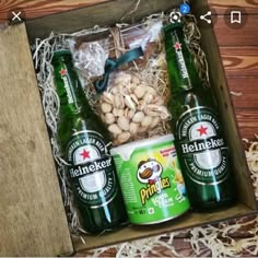 an open box with beer and nuts in it